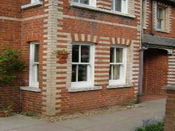 LIVERPOOL , WATERLOO - Replacement Bygone PvcU Vertical sliding sash windows in a whitewood finish. The windows come with "run Throgh" Sash Horns as standard with macanically jointed sashes to look like traditional timber box sash windows 